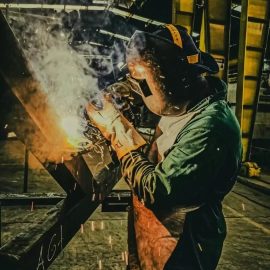 pexels-photo-30790481-30790481 A skilled welder works on metal fabrication in a Brazilian factory, showcasing industrial precision.